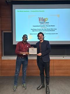 Suresh Bolusani (competition commitee) with Computational Competition Honorable Mention awardee Paul Strang